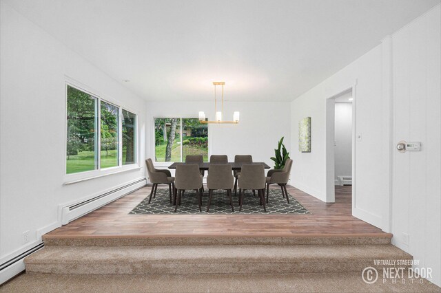 1757 Westlane Dr NE, Grand Rapids, MI 49505 - dining area with a baseboard heating unit, a chandelier, wood finished floors, and a baseboard radiator