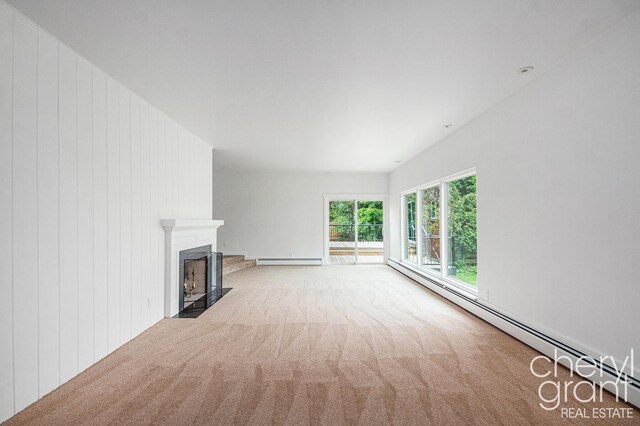 1757 Westlane Dr NE, Grand Rapids, MI 49505 - unfurnished living room featuring a baseboard heating unit, carpet flooring, a fireplace with flush hearth, a baseboard radiator, and wood walls