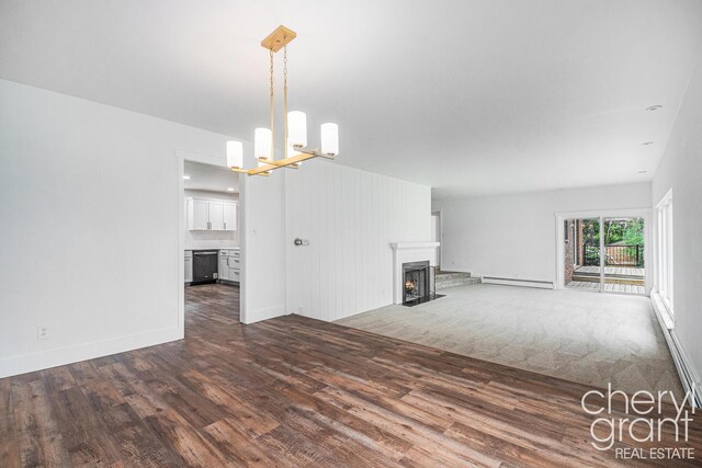 1757 Westlane Dr NE, Grand Rapids, MI 49505 - unfurnished living room featuring wood finished floors, a fireplace with flush hearth, a chandelier, and baseboard heating