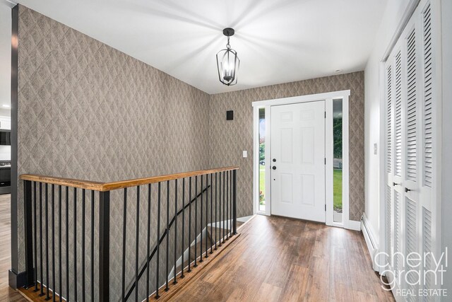 1757 Westlane Dr NE, Grand Rapids, MI 49505 - foyer entrance featuring wood finished floors and wallpapered walls