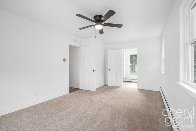 1757 Westlane Dr NE, Grand Rapids, MI 49505 - carpeted spare room featuring baseboard heating and ceiling fan