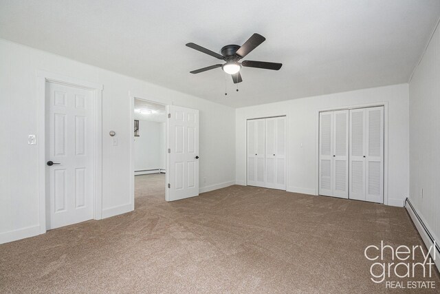 1757 Westlane Dr NE, Grand Rapids, MI 49505 - unfurnished bedroom with a baseboard heating unit, carpet, two closets, and ceiling fan
