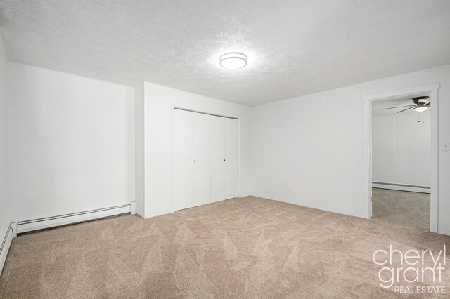 1757 Westlane Dr NE, Grand Rapids, MI 49505 - unfurnished bedroom with a baseboard radiator, carpet flooring, a textured ceiling, baseboard heating, and a closet