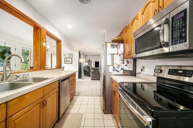 55 E Lewis Ave, Milan, MI 48160 - kitchen featuring appliances with stainless steel finishes, a sink, light colored carpet, light countertops, and light tile patterned floors