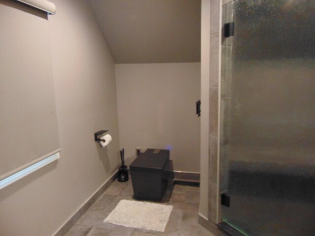 10114 Lincoln Dr, Huntington Woods, MI 48070 - bathroom featuring vaulted ceiling, a stall shower, and baseboards