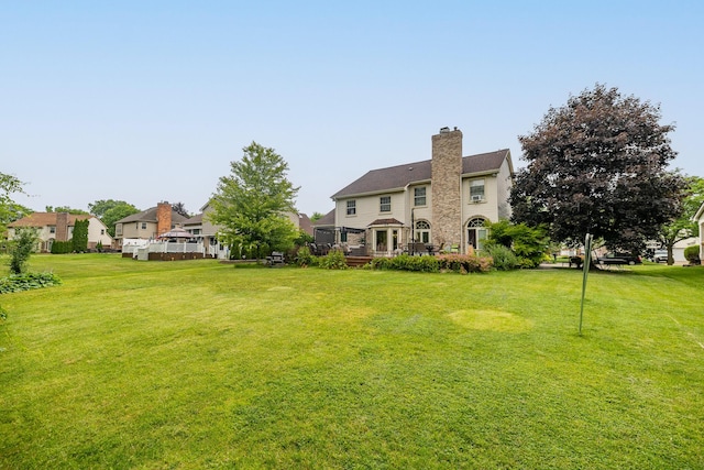 45801 Henley Dr, Canton, MI 48187 - back of property with a lawn, a deck, a chimney, and a residential view