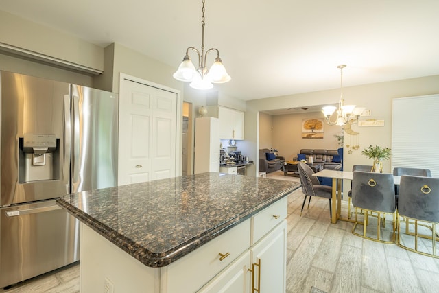 45801 Henley Dr, Canton, MI 48187 - kitchen with stainless steel refrigerator with ice dispenser, a chandelier, light wood-style flooring, white cabinets, and pendant lighting