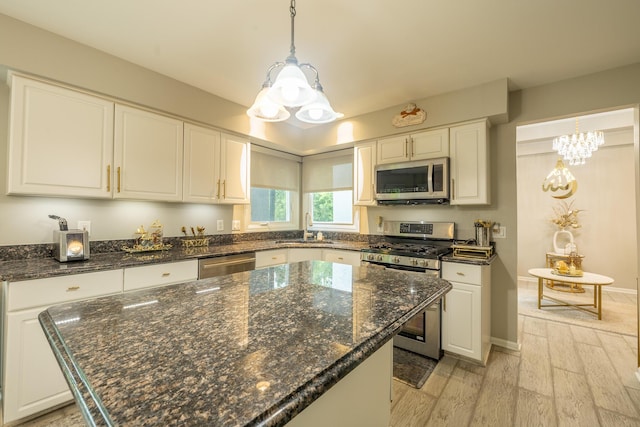 45801 Henley Dr, Canton, MI 48187 - kitchen featuring stainless steel appliances, light wood finished floors, white cabinetry, and a center island