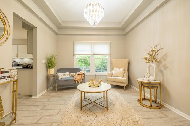 45801 Henley Dr, Canton, MI 48187 - living area featuring light wood-style flooring, a chandelier, and a tray ceiling