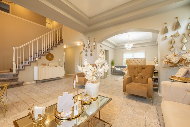 45801 Henley Dr, Canton, MI 48187 - living room with a raised ceiling, arched walkways, stairs, and wood finished floors
