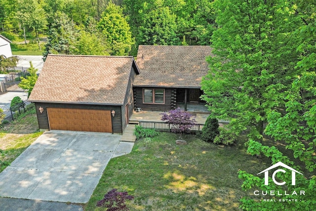 17031 Quincy St, Holland, MI 49424 - view of front of home with an attached garage, concrete driveway, roof with shingles, and a deck