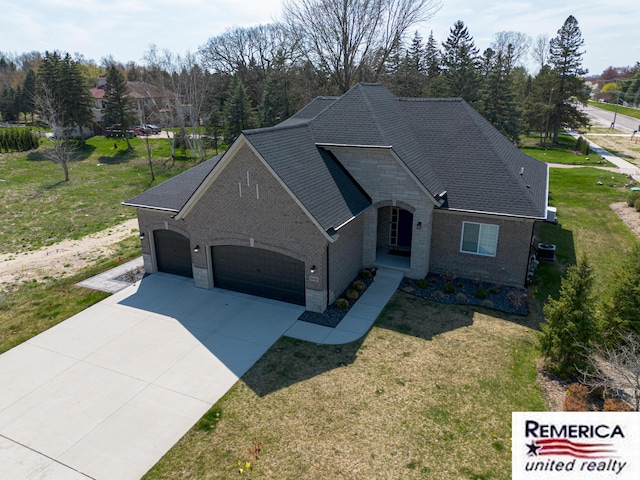 52951 Royal Park Ave, Utica, MI 48315 - french provincial home with a garage, brick siding, a front yard, and concrete driveway