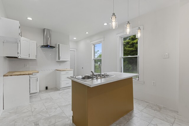 3008 Lothrop St, Detroit, MI 48206 - kitchen featuring ventilation hood, light marble finish flooring, white cabinets, an island with sink, and recessed lighting