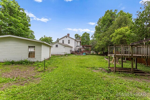 409 Rust Ave, Big Rapids, MI 49307 - view of grassy yard featuring a deck