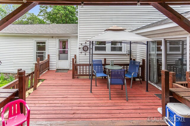 409 Rust Ave, Big Rapids, MI 49307 - wooden terrace with outdoor dining space