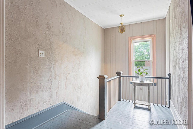 409 Rust Ave, Big Rapids, MI 49307 - stairway with hardwood / wood-style floors, ornamental molding, and wallpapered walls