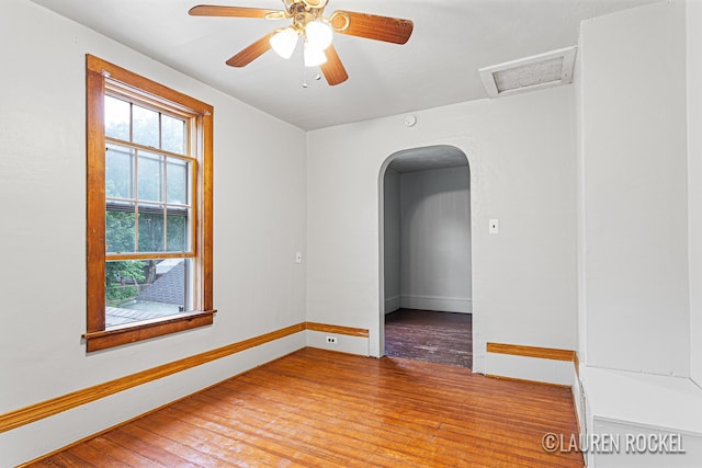 409 Rust Ave, Big Rapids, MI 49307 - spare room with wood finished floors, attic access, arched walkways, and ceiling fan