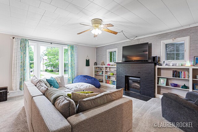 409 Rust Ave, Big Rapids, MI 49307 - living area featuring carpet, a brick fireplace, crown molding, and a ceiling fan