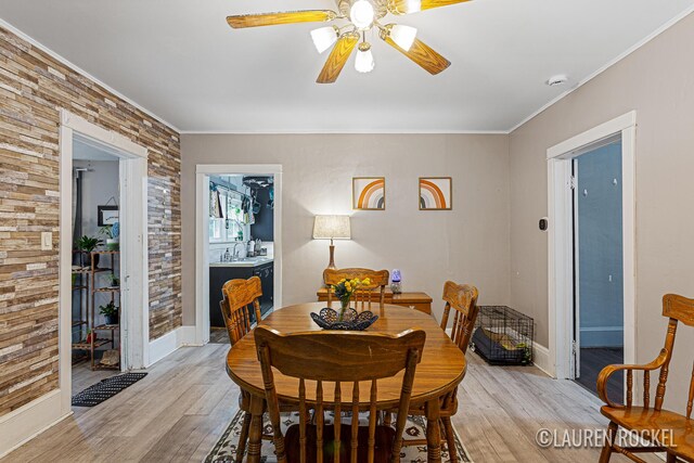 409 Rust Ave, Big Rapids, MI 49307 - dining room featuring light wood finished floors, a ceiling fan, and ornamental molding