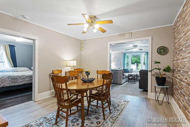 409 Rust Ave, Big Rapids, MI 49307 - dining space featuring ceiling fan, wood finished floors, and crown molding