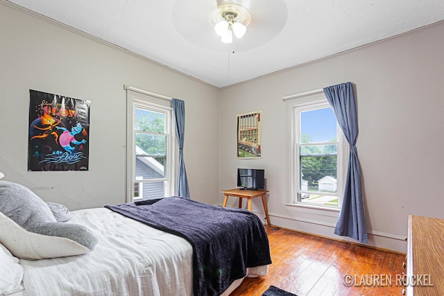 409 Rust Ave, Big Rapids, MI 49307 - bedroom with crown molding, wood finished floors, and ceiling fan
