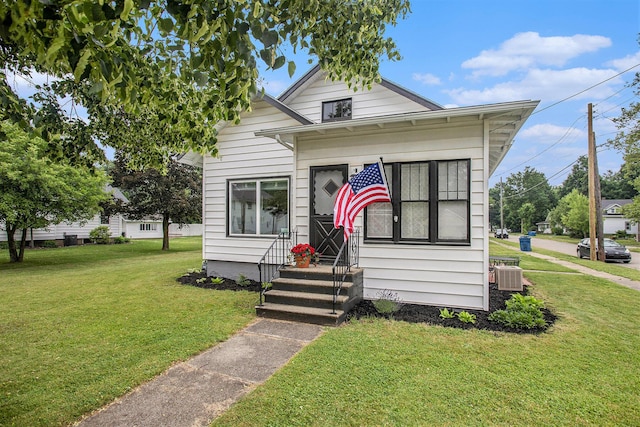 255 E Corey St, Bronson, MI 49028 - view of front of property featuring central AC unit and a front yard