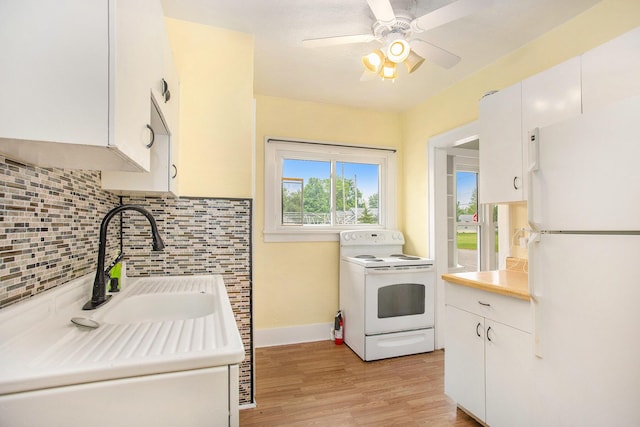 255 E Corey St, Bronson, MI 49028 - kitchen with white appliances, decorative backsplash, light countertops, light wood-style flooring, and baseboards