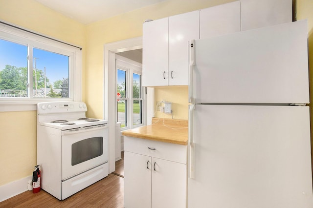 255 E Corey St, Bronson, MI 49028 - kitchen featuring white appliances, light wood-style flooring, light countertops, white cabinets, and baseboards