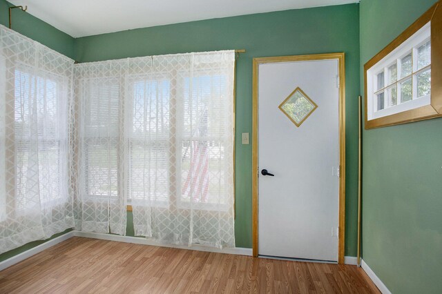 255 E Corey St, Bronson, MI 49028 - empty room with wood finished floors and baseboards