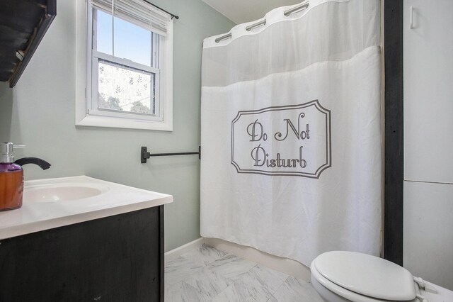 255 E Corey St, Bronson, MI 49028 - full bath featuring marble look tile flooring, toilet, vanity, and baseboards
