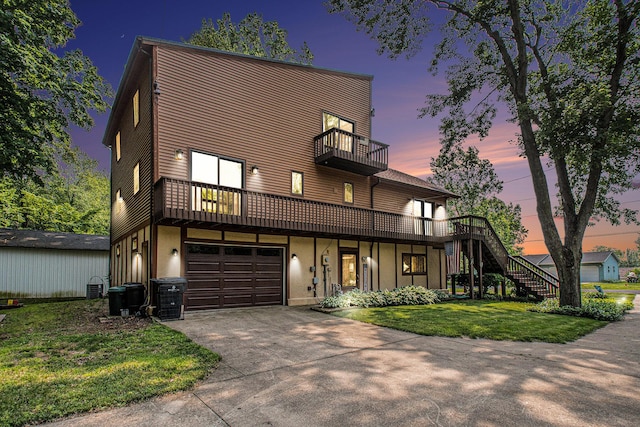50041 David Dr, Dowagiac, MI 49047 - view of front of house with a balcony, a lawn, driveway, stairway, and a garage