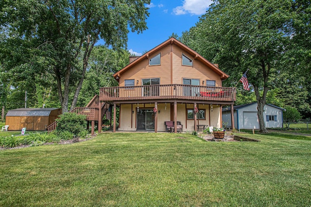 50041 David Dr, Dowagiac, MI 49047 - back of property with a deck, a yard, stairway, a storage shed, and a detached garage