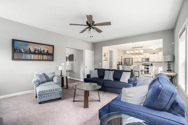 3935 Riley Rdg, Portage, MI 49024 - living area featuring a ceiling fan, a chandelier, and light carpet
