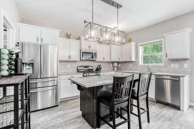 3935 Riley Rdg, Portage, MI 49024 - kitchen with stainless steel appliances, light wood finished floors, and backsplash
