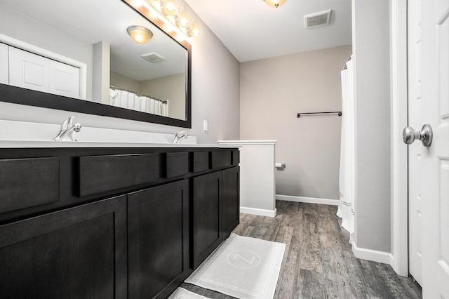 3935 Riley Rdg, Portage, MI 49024 - bathroom featuring wood finished floors and double vanity