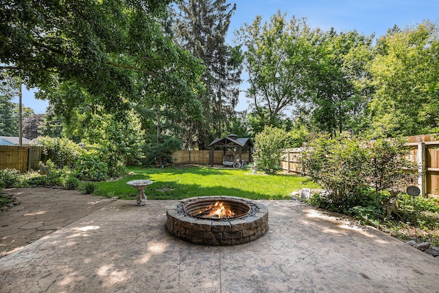 106 E Mechanic St, Yale, MI 48097 - fenced backyard with a fire pit and a patio