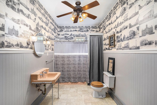 106 E Mechanic St, Yale, MI 48097 - bathroom with wallpapered walls, wainscoting, a ceiling fan, and curtained shower