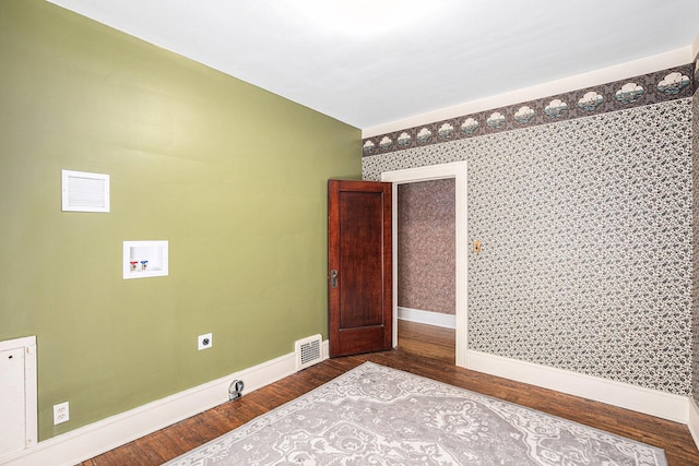 106 E Mechanic St, Yale, MI 48097 - empty room featuring baseboards and dark wood-type flooring