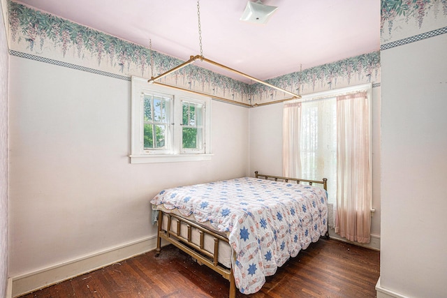 106 E Mechanic St, Yale, MI 48097 - bedroom featuring baseboards and dark wood-style flooring