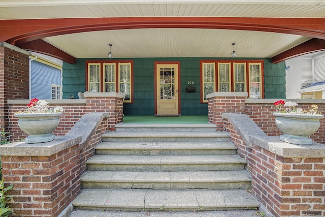 106 E Mechanic St, Yale, MI 48097 - property entrance with a porch and brick siding