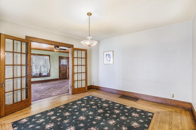 106 E Mechanic St, Yale, MI 48097 - empty room featuring french doors and wood finished floors
