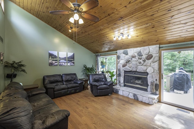 7715 Marquis Dr, Dexter, MI 48130 - living area featuring wood ceiling, a stone fireplace, ceiling fan, wood finished floors, and high vaulted ceiling