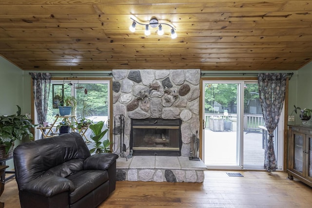7715 Marquis Dr, Dexter, MI 48130 - living room featuring vaulted ceiling, wood ceiling, wood-type flooring, and a fireplace