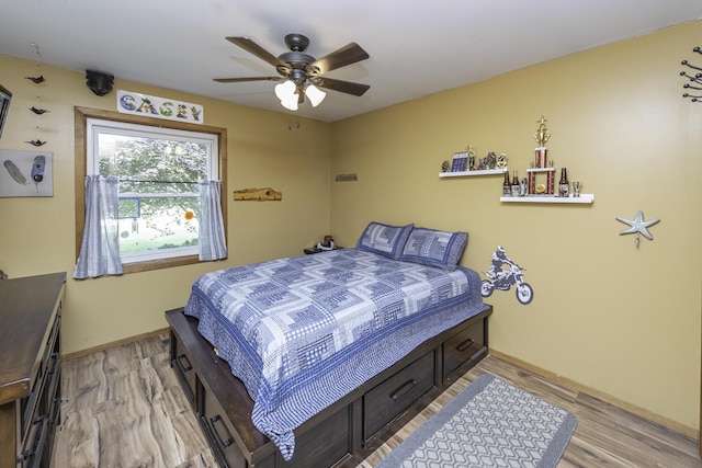 7715 Marquis Dr, Dexter, MI 48130 - bedroom with light wood finished floors and a ceiling fan