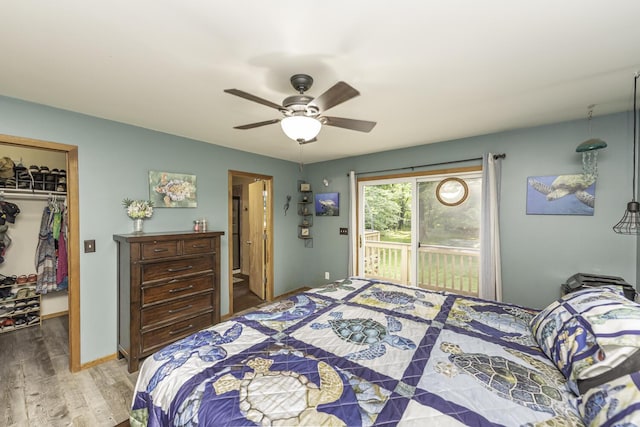 7715 Marquis Dr, Dexter, MI 48130 - bedroom with wood finished floors, a walk in closet, access to exterior, and ceiling fan