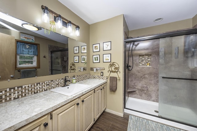 7715 Marquis Dr, Dexter, MI 48130 - full bath with vanity, a shower stall, wood finished floors, and backsplash