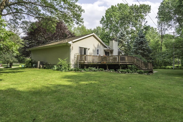 7715 Marquis Dr, Dexter, MI 48130 - back of house featuring a deck, a yard, and a chimney