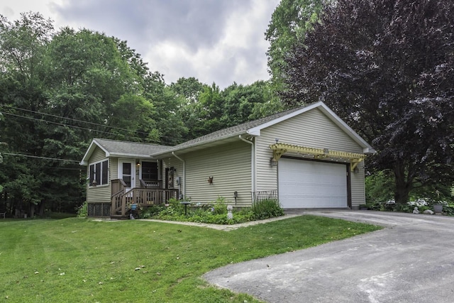 7715 Marquis Dr, Dexter, MI 48130 - single story home featuring an attached garage, asphalt driveway, a front lawn, and roof with shingles
