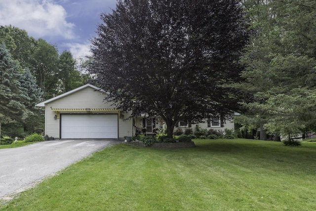 7715 Marquis Dr, Dexter, MI 48130 - view of front of home with an attached garage, asphalt driveway, and a front lawn