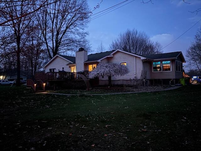 7715 Marquis Dr, Dexter, MI 48130 - rear view of property with a deck, a yard, and a chimney